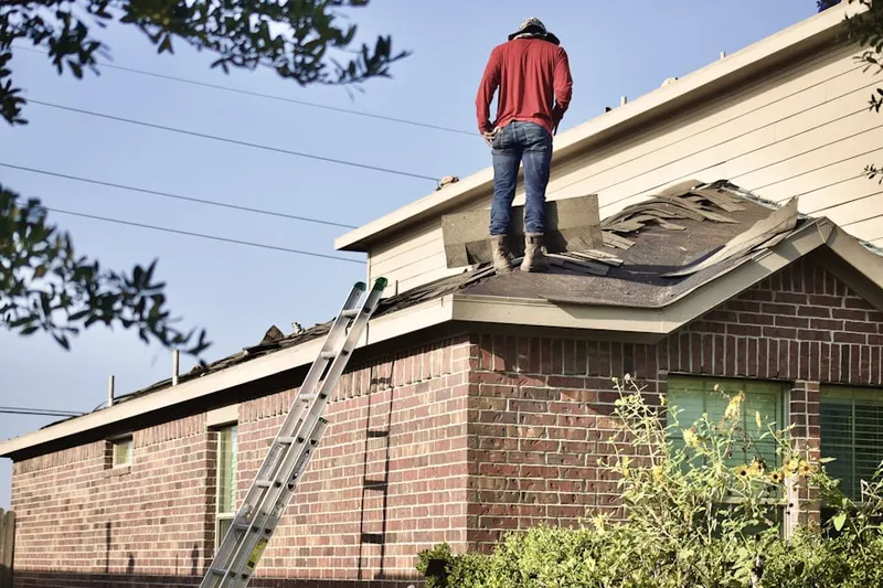 Professional roofer working on a residential roof in Traverse City